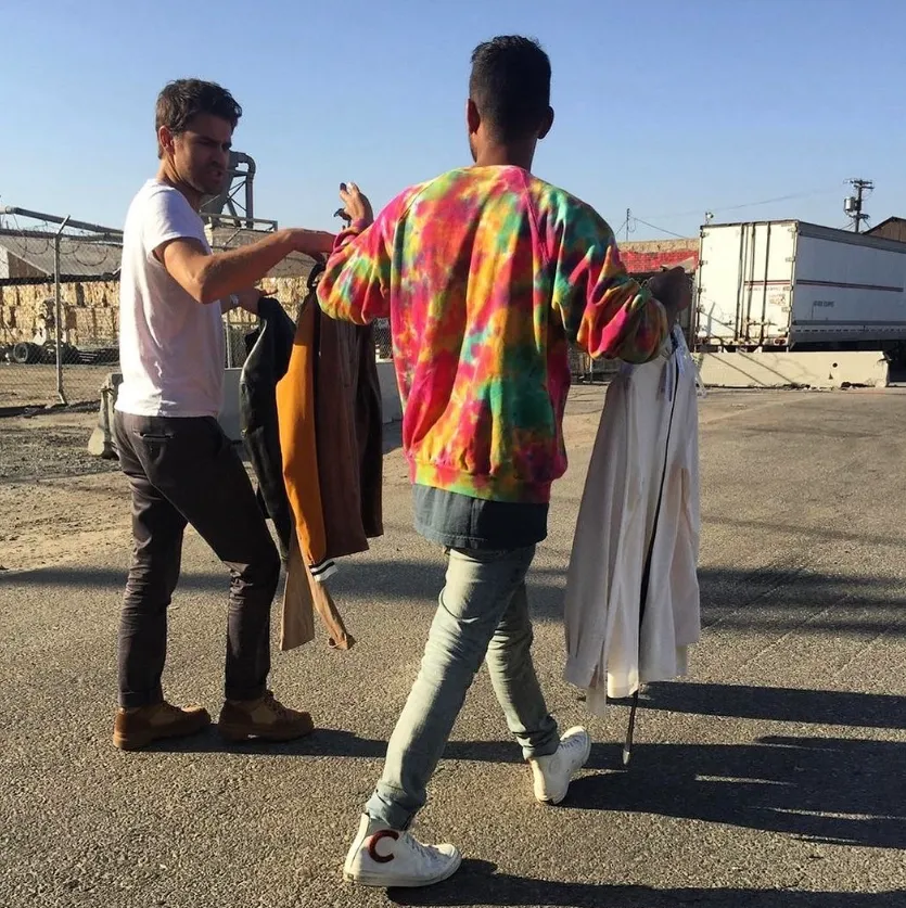 Justin adjusting a colorful jacket on location