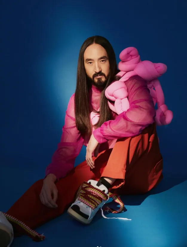 Editorial styling in pink against a blue backdrop