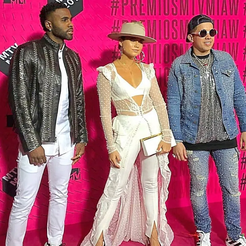 Red carpet styling against a bright pink backdrop